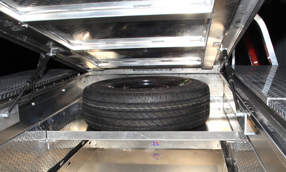 Spare tires are always tough to find a spot for on a service body. Highway Products has an elevated shelf located in the front of the bed that is hard to use space anyway.